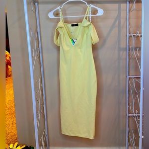 Light yellow midi dress with form fit, low cut V neck, and delicate, fun straps!
